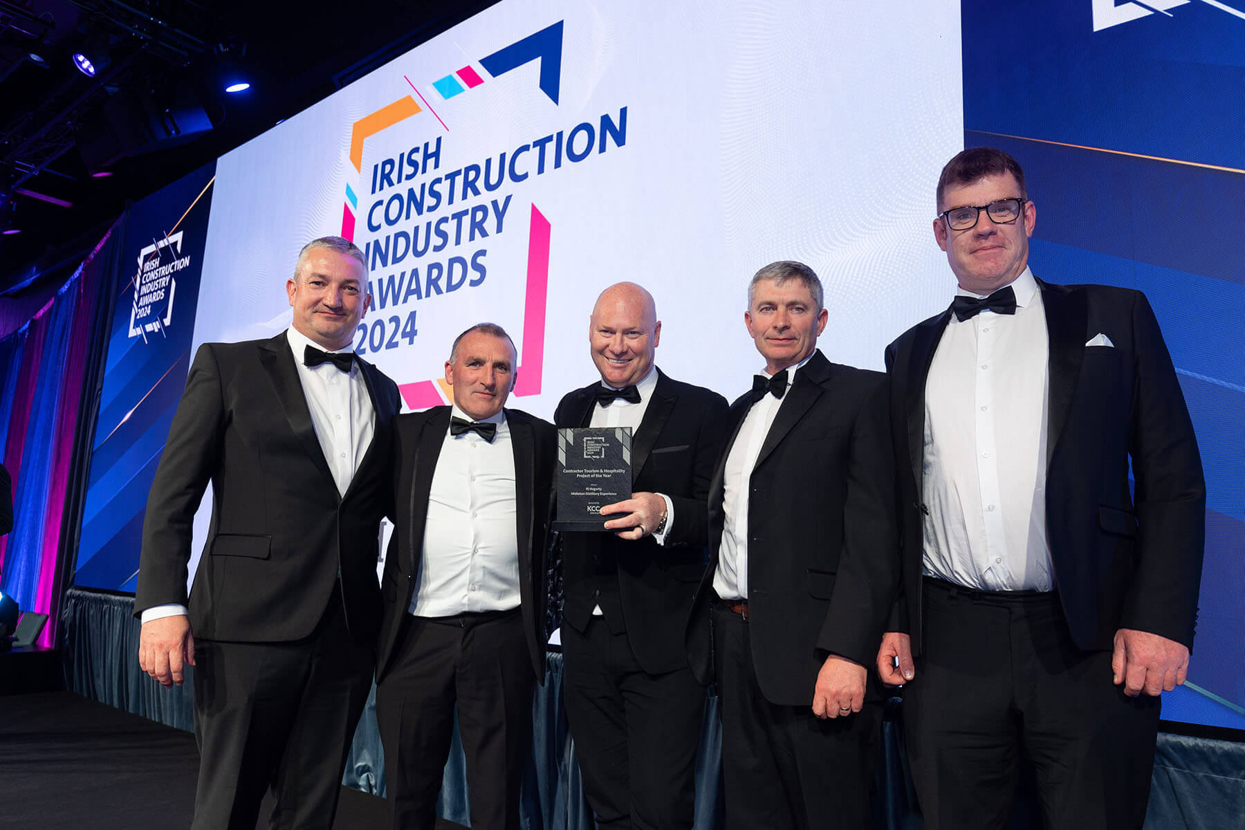 irish construction awards smiling on stage